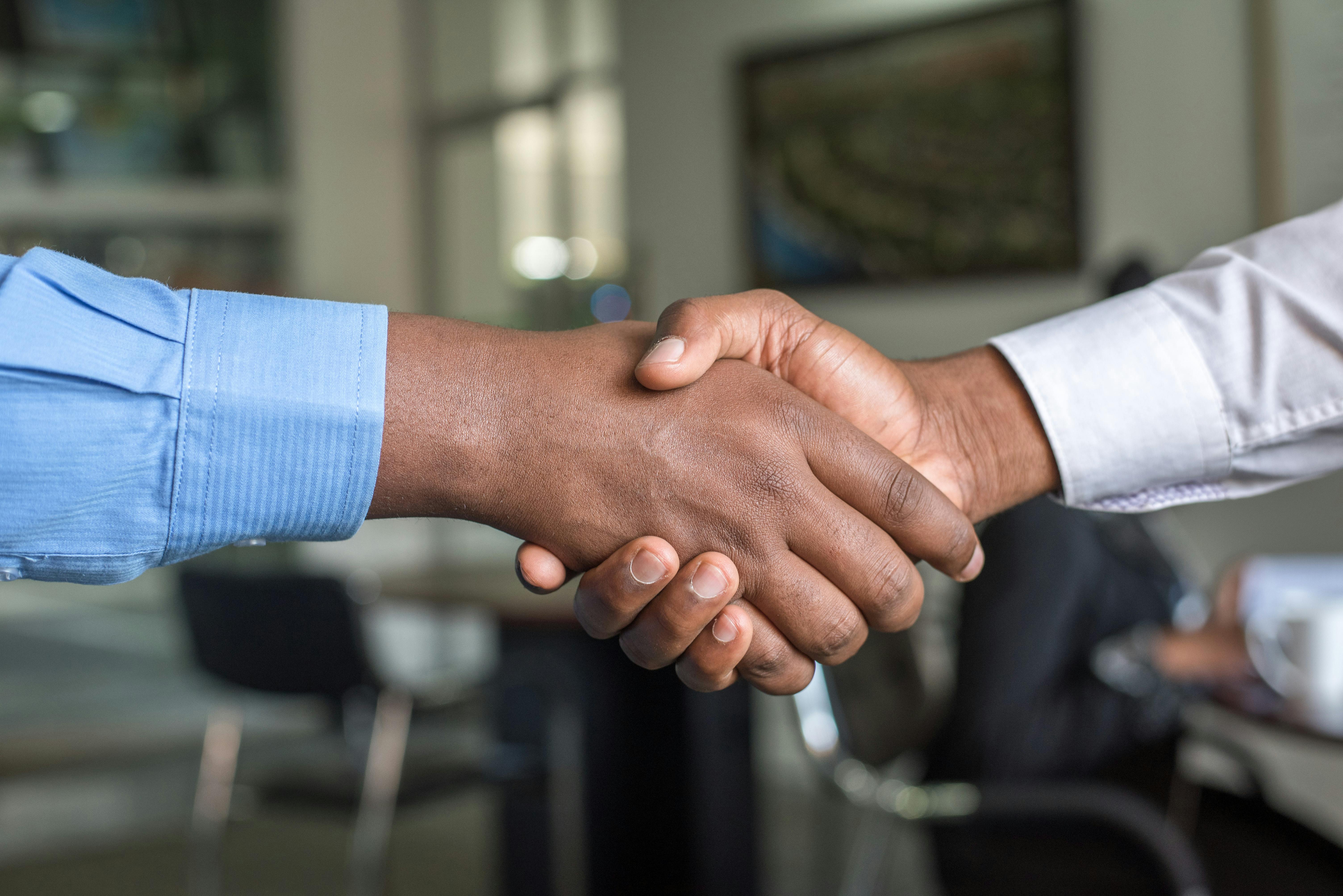 Professional handshake representing trust and commitment